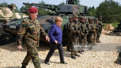 German chancellor Angela Merkel passer by a tank of the German armed forces Bundeswehr